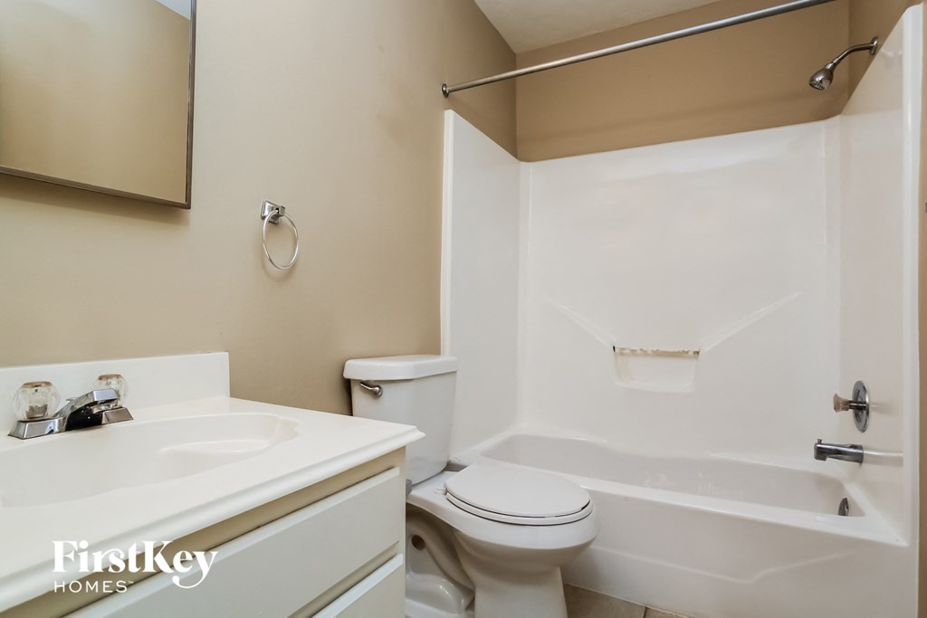 a bathroom with a sink toilet and a bath tub