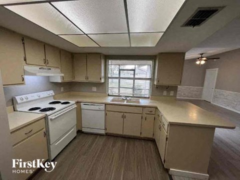 A kitchen with a stove top oven and a dishwasher.