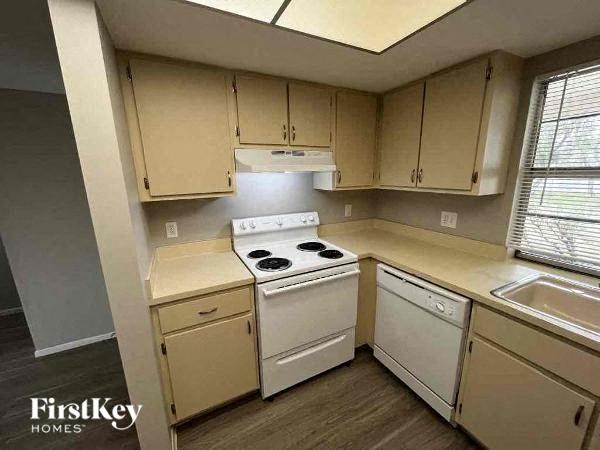 A kitchen with a stove top oven and a dishwasher.