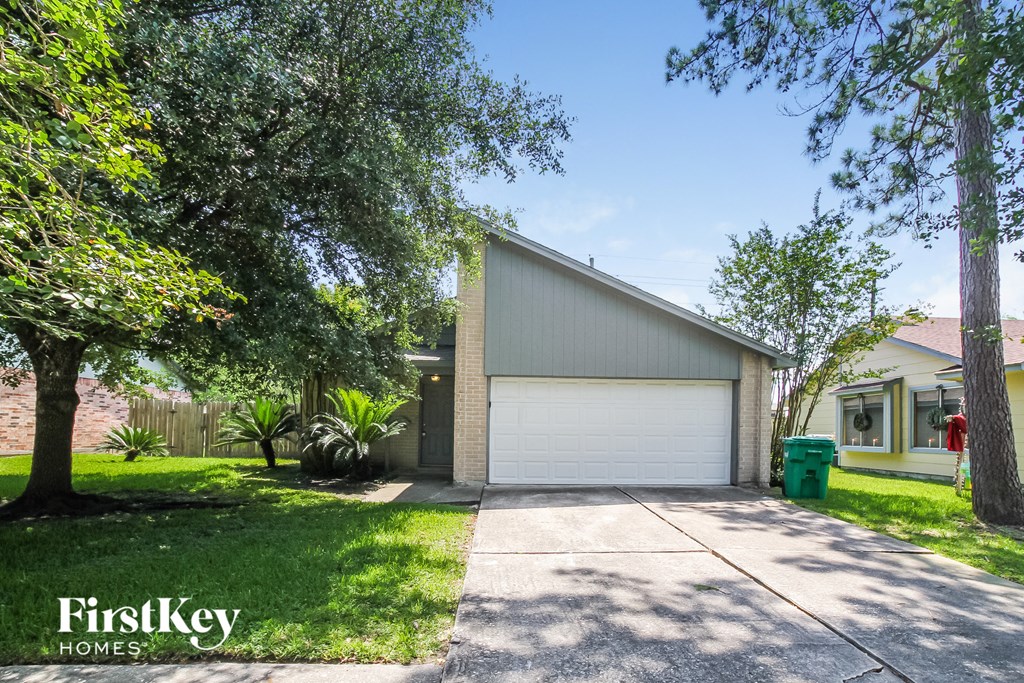 a garage with a white garage door and a driveway