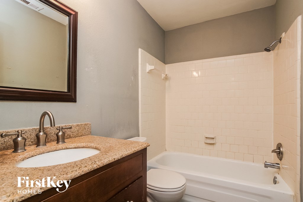 a bathroom with a sink and a tub and a toilet