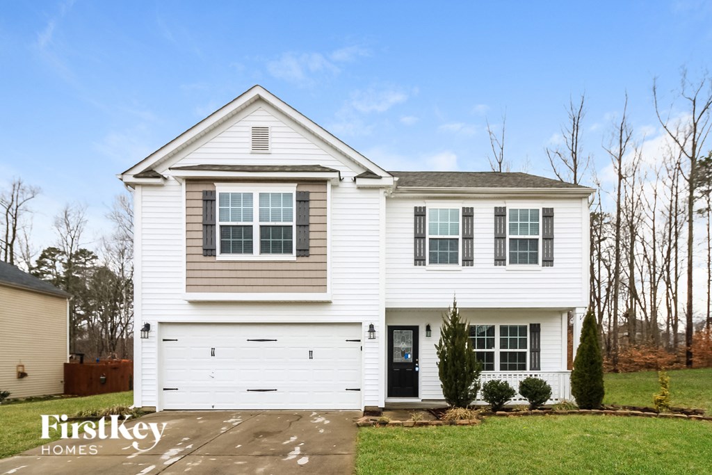 A two-story house with a garage is for sale.
