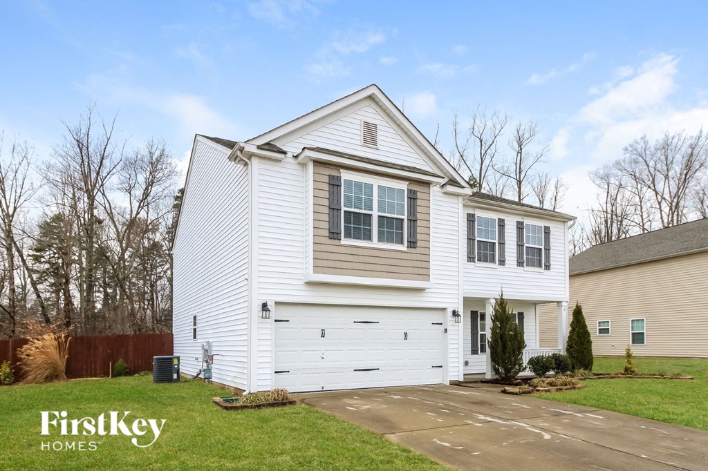 A two-story house with a garage is for sale by FirstKey Homes.