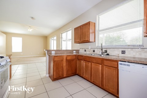 A kitchen with wooden cabinets and a washing machine.