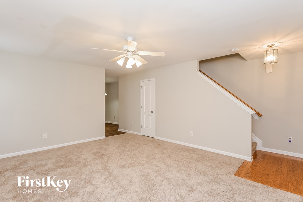 the living room and dining room are spacious and lighted by a ceiling fan