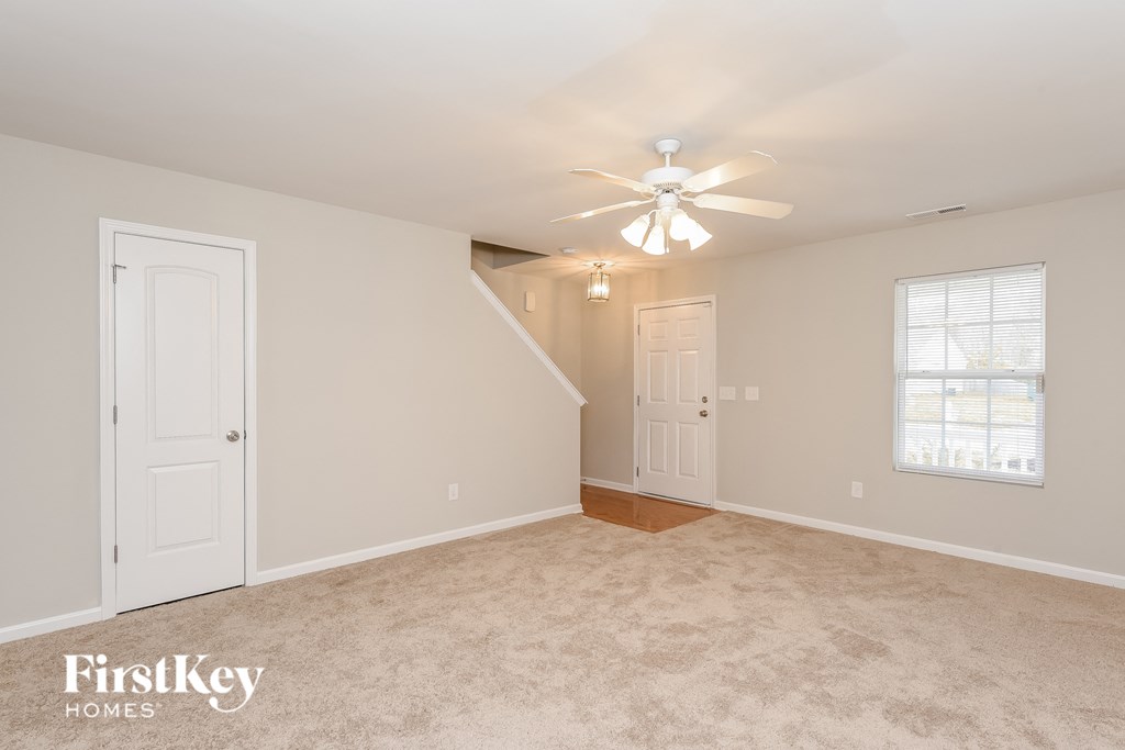 a bedroom with a ceiling fan and a white door