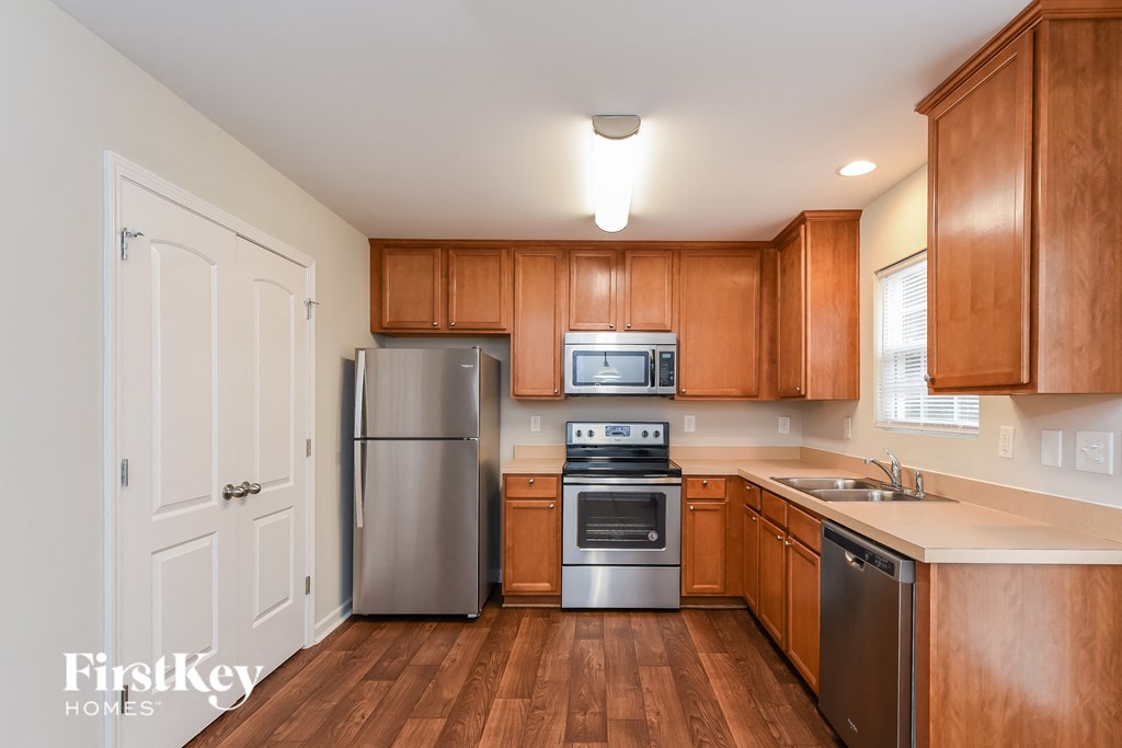 a kitchen with wooden cabinets and stainless steel appliances