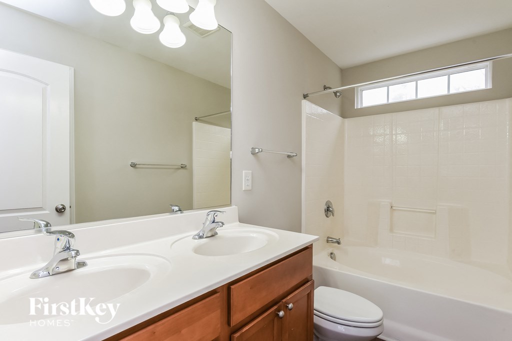 a bathroom with a sink and a toilet and a tub