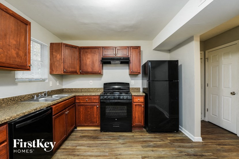 a kitchen with black appliances and wooden cabinets
