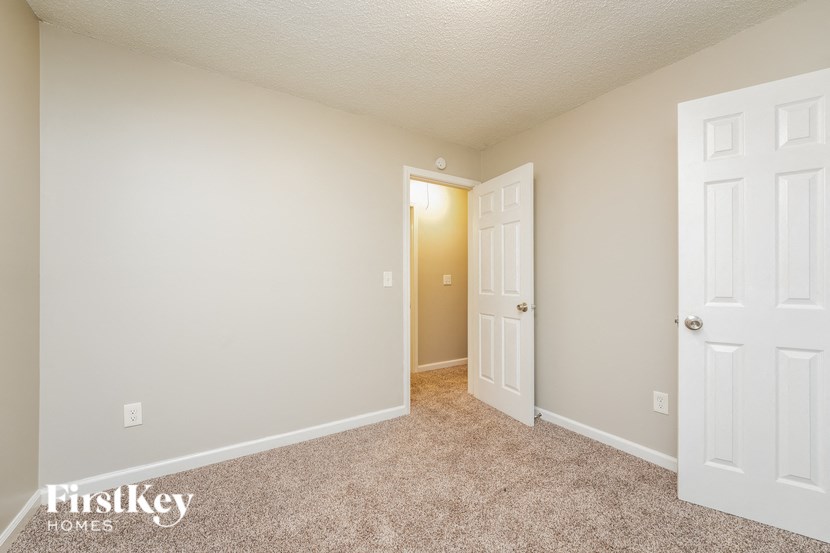 a bedroom with two closets and a door to a hallway