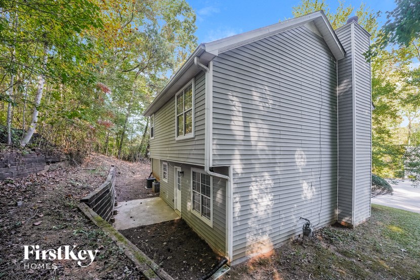 a gray house with a ramp to the side of it