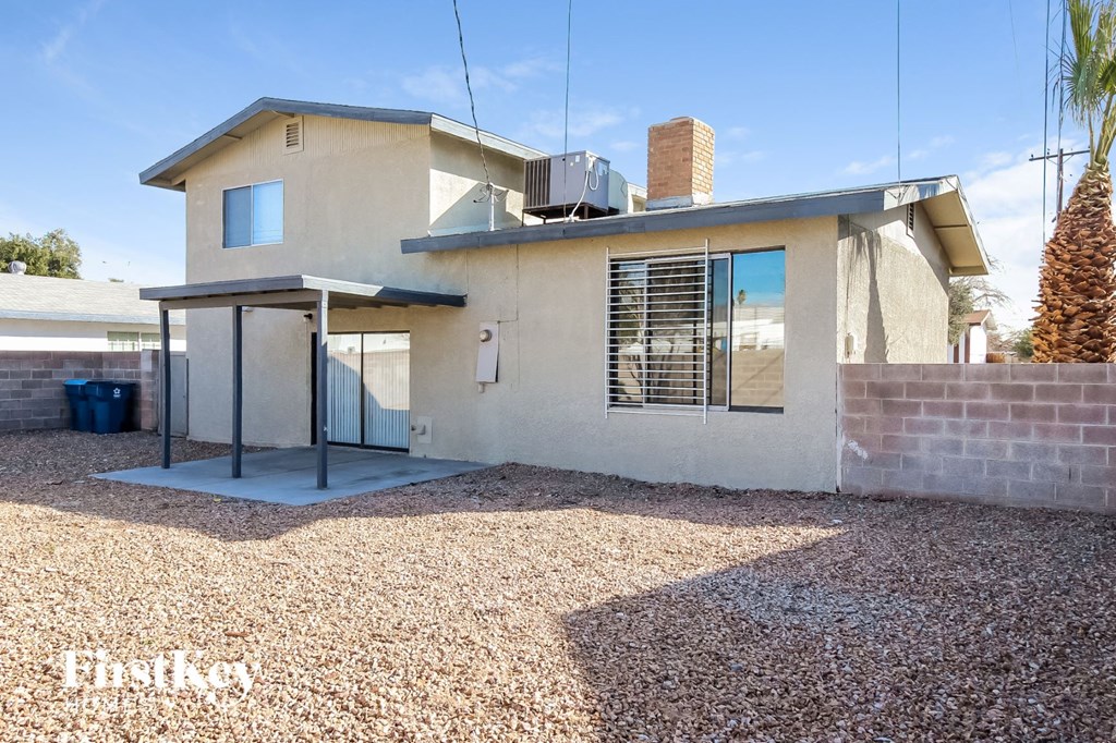 a small house with a yard and a glass door