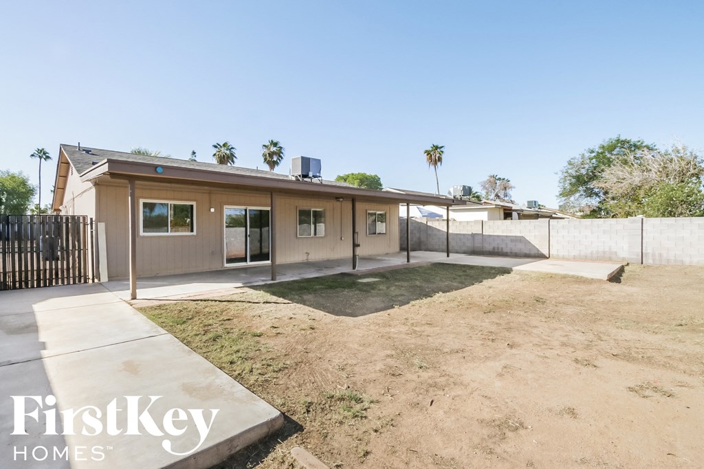 a small house with a yard and a fence