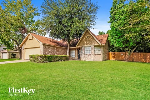 A house with a lawn in front of it.