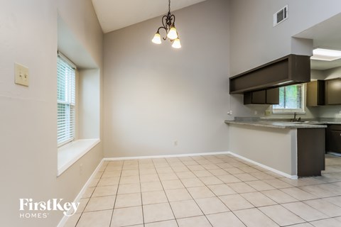 A kitchen area with a sink and a window.