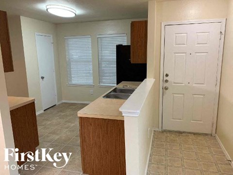 A kitchen area with a sink and cabinets.