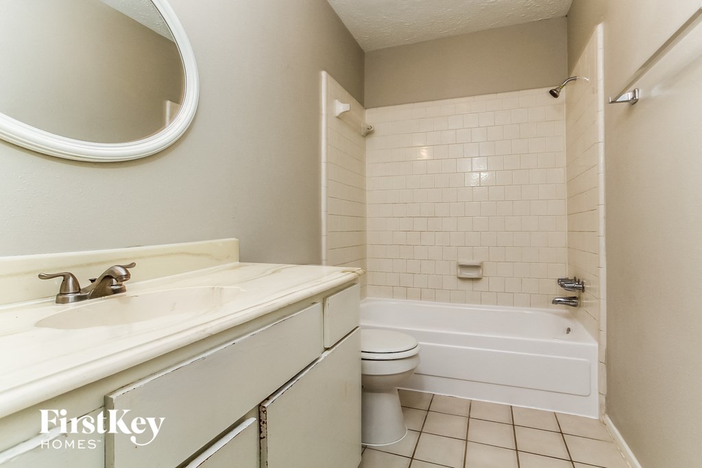 a bathroom with a sink and a toilet and a bath tub