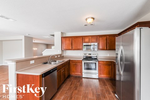 A kitchen with wooden cabinets and stainless steel appliances.
