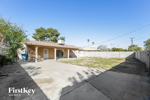 a small house with a driveway and a yard with grass