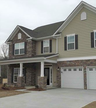 a house with a white garage door in front of it