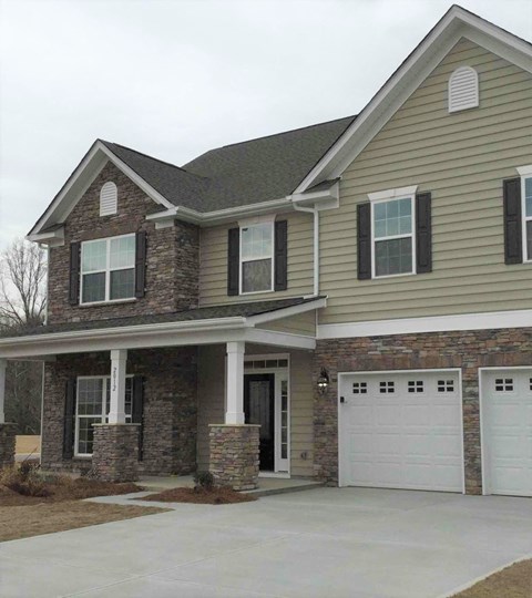 a house with a white garage door in front of it