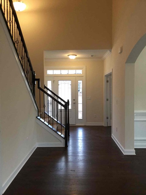 a view of the entryway of a house with a staircase