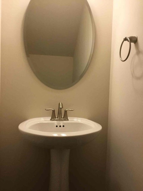a small bathroom with a sink and a mirror