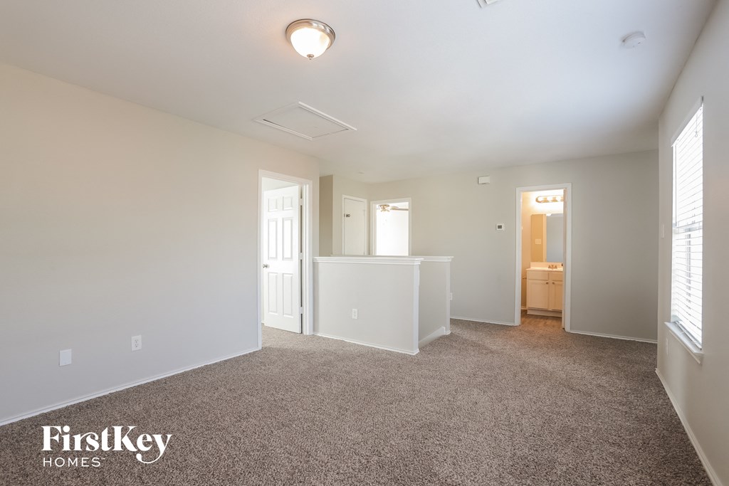 a living room with a carpeted floor and white walls