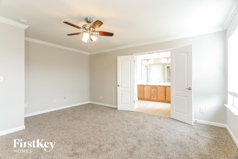 a empty living room with a ceiling fan