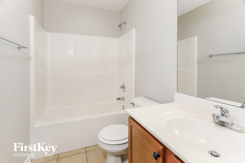 a bathroom with a sink toilet and a bath tub