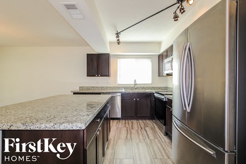 a kitchen with granite counter tops and stainless steel appliances