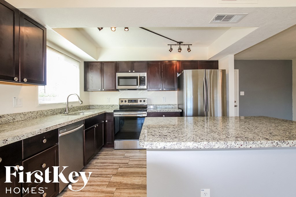 a kitchen with granite counter tops and stainless steel appliances