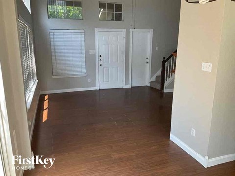 an empty living room with a hard wood floor