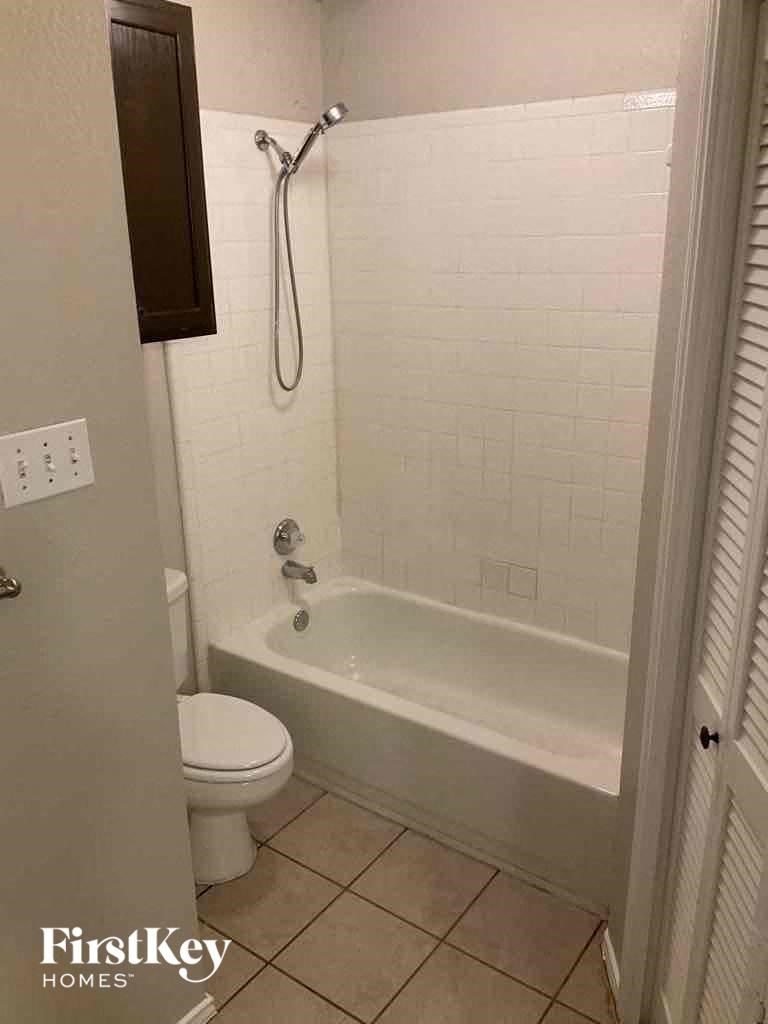 a small bathroom with a shower and a toilet
