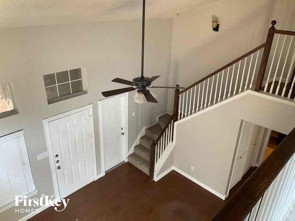 a stairway in a home with a ceiling fan