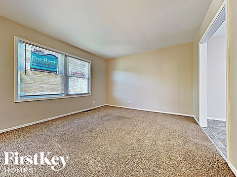 an empty living room with a large window