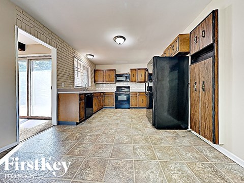 a kitchen with black appliances and wooden cabinets