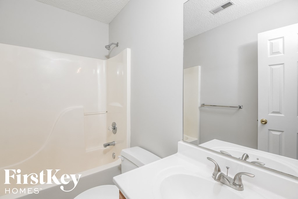 a bathroom with a sink and a toilet and a shower