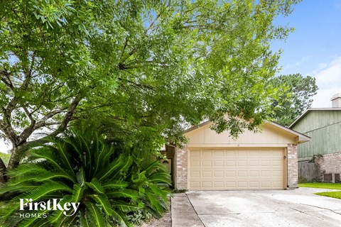 a garage door in front of a house with a tree