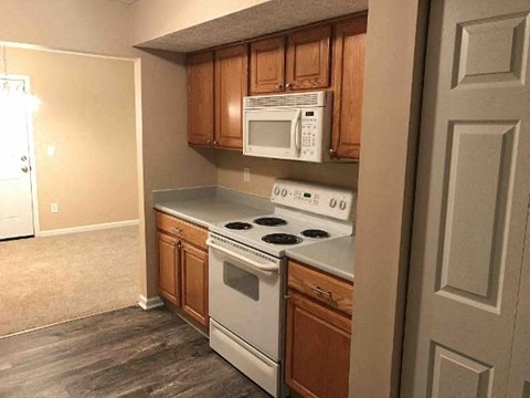A kitchen with a stove top oven and microwave.