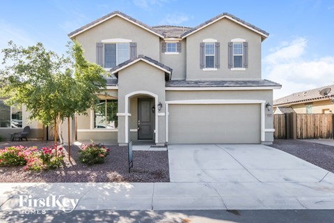 A two-story house with a garage is for sale.