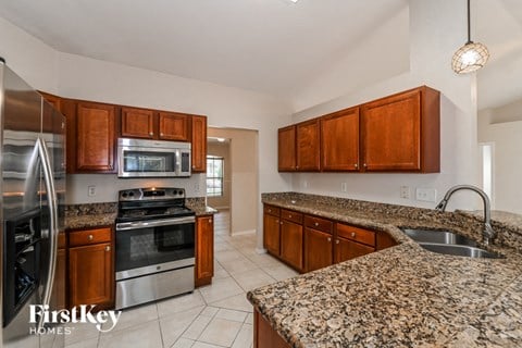 a kitchen with granite counter tops and stainless steel appliances