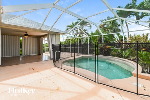 a pool in a glass enclosure in a house with a pool