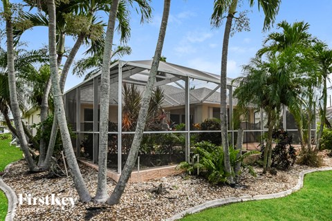 a house with palm trees in front of it