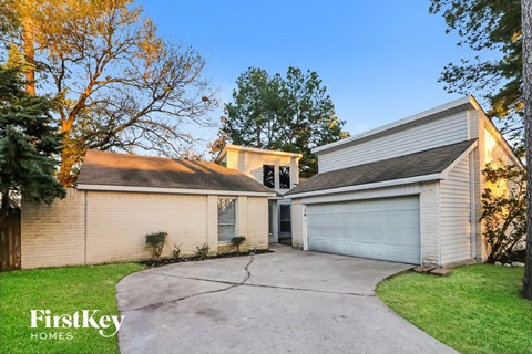 a white house with a driveway and a garage door