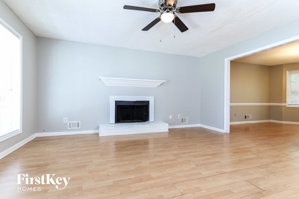 the living room has a fireplace and hardwood floors