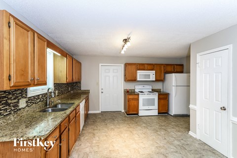a kitchen with wooden cabinets and white appliances