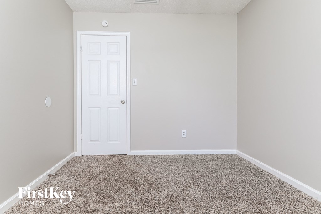 a room with carpet and a white door