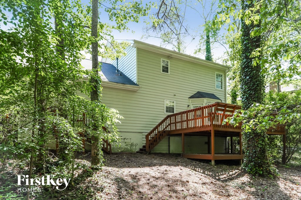 the back of a house with a deck and a wooden deck