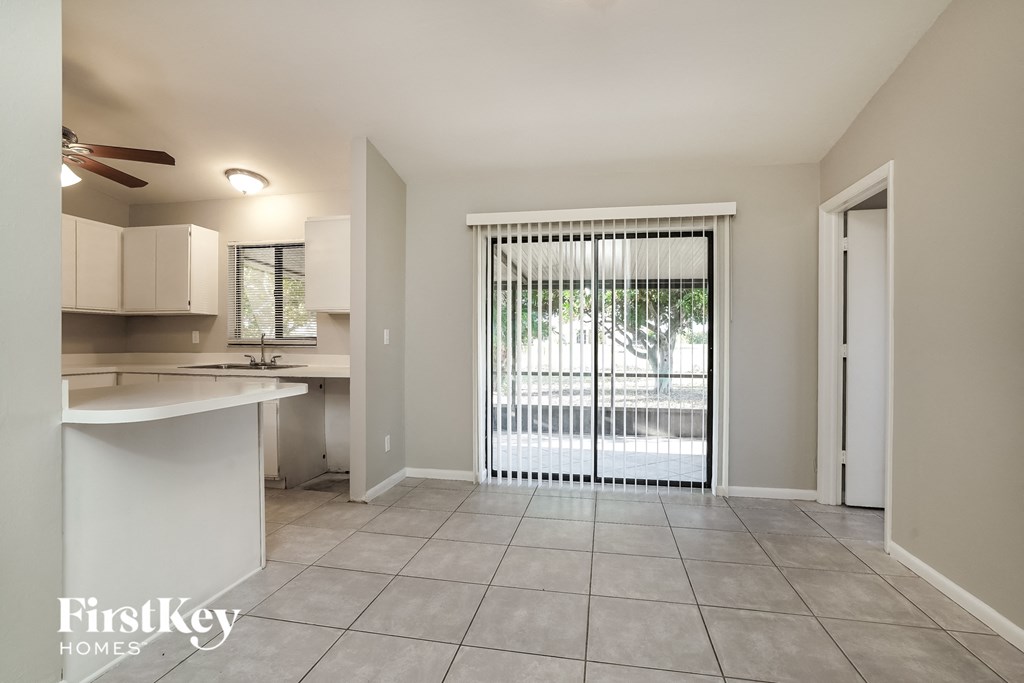 a kitchen with a sliding glass door leading to a patio